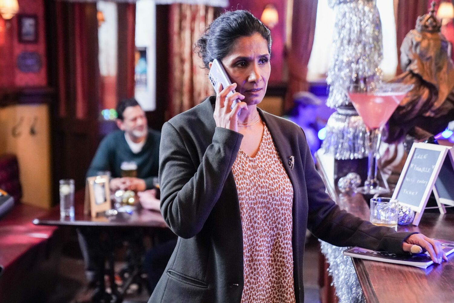 Suki Panesar on the phone looking worried in The Queen Vic