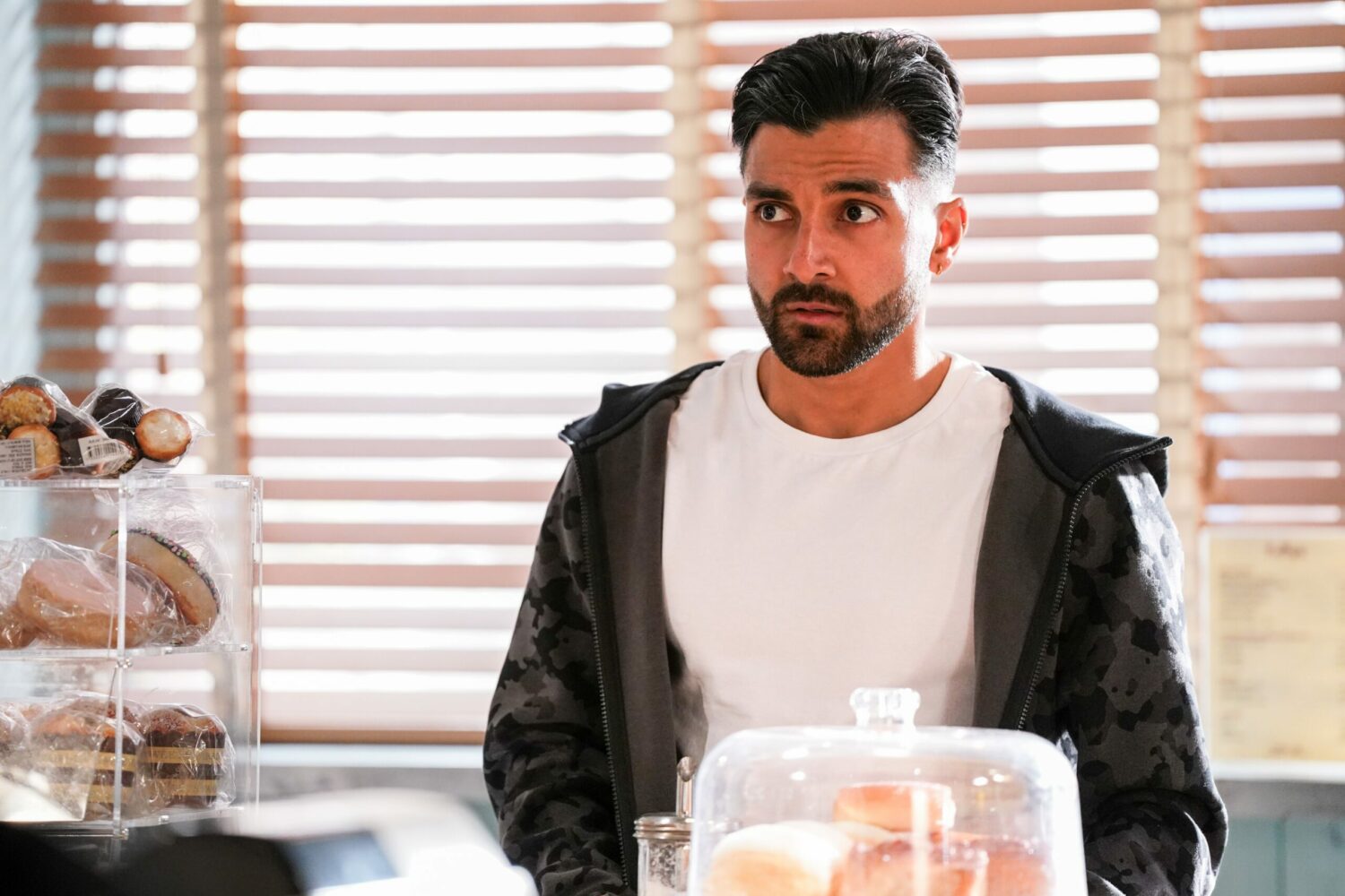 Vinny looks concerned in EastEnders as he listens to Finlay in the cafe