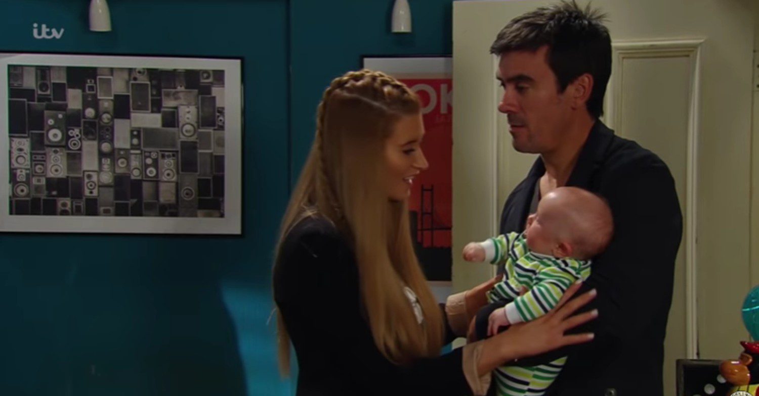 Cain and Debbie holding baby Moses on Emmerdale