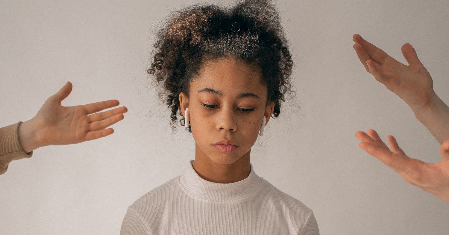 Sad teenager frowns with hands next to her 