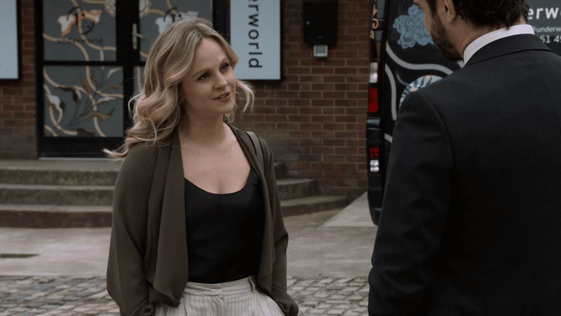 Sarah Platt smiles on Coronation Street