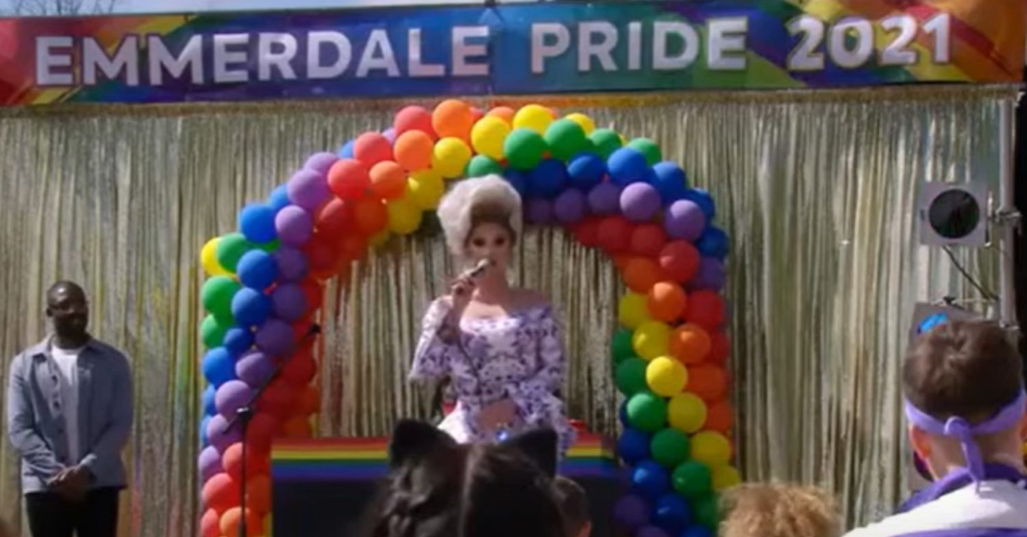 Emmerdale's The Vivienne is standing by some rainbow balloons at Emmerdale Pride 2021