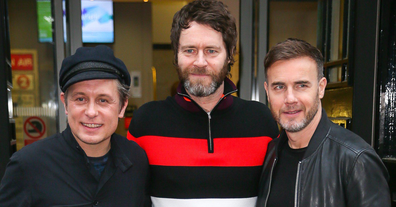 Take That members smiling outside 
