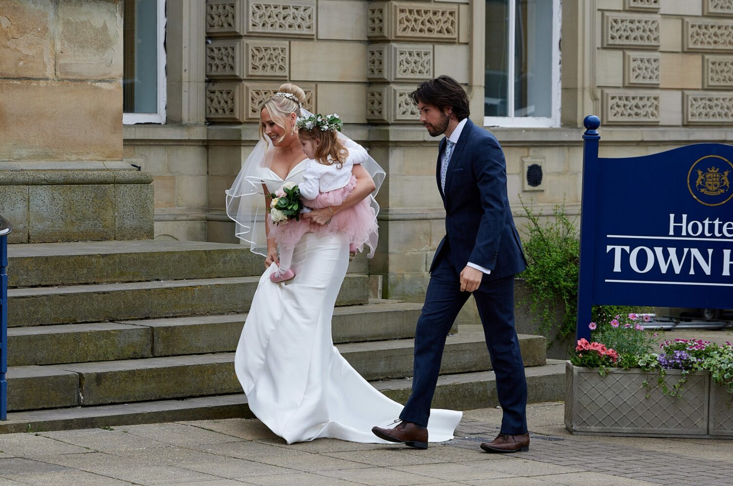 Tracy walking next to a handsome man in her wedding dress on Emmerdale