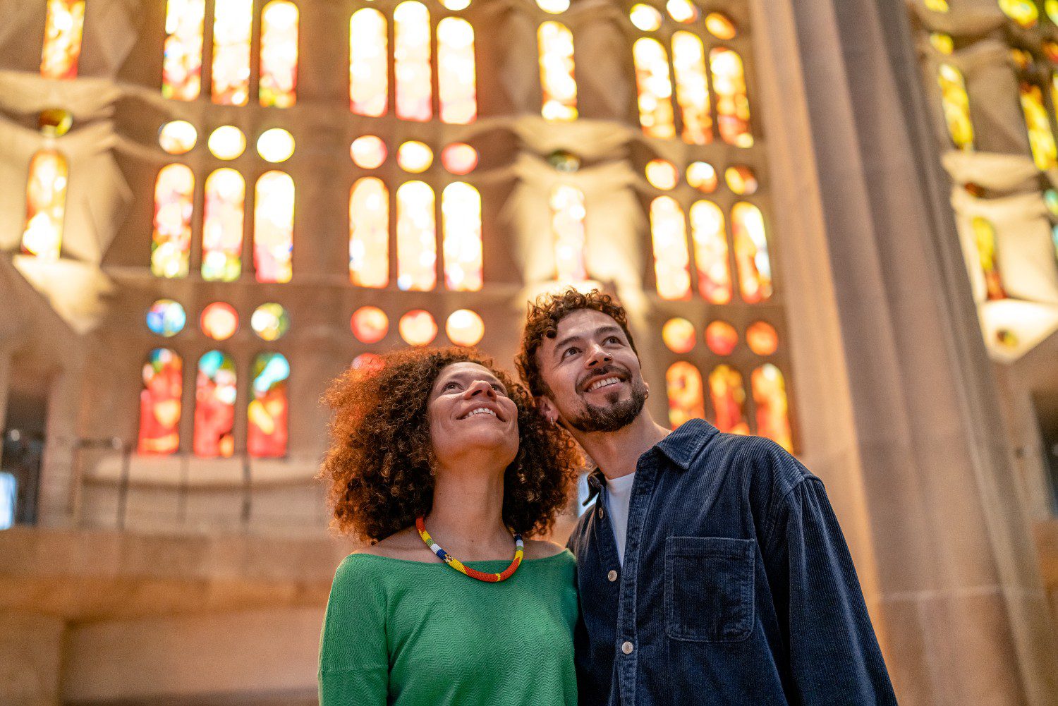 Tourists smile in Barcelona's Sagrada Familia