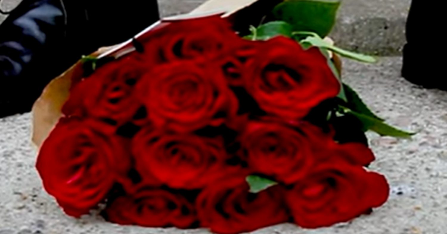 A bouquet of red roses on the floor
