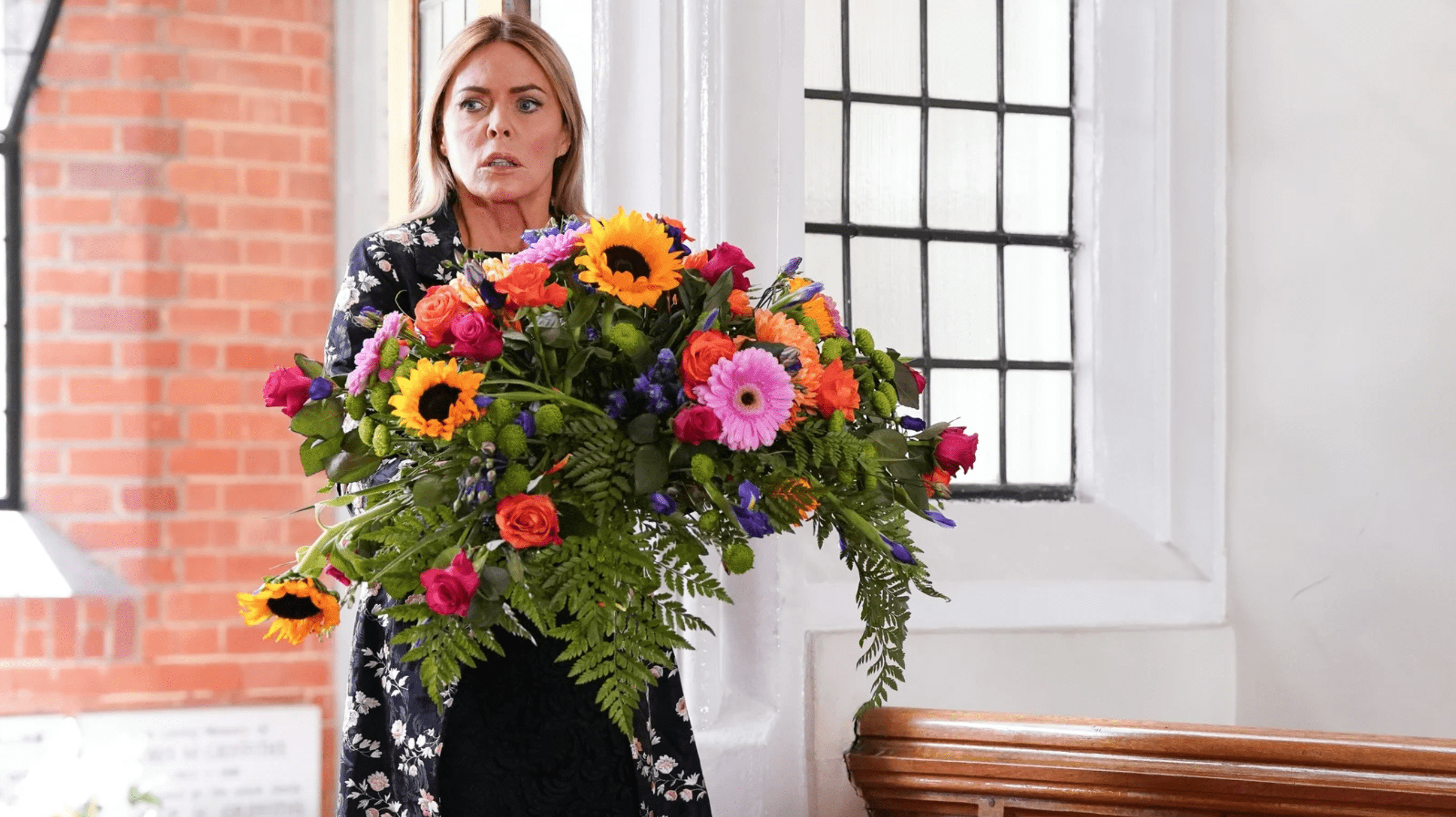 Patsy Kensit in EastEnders holding flowers