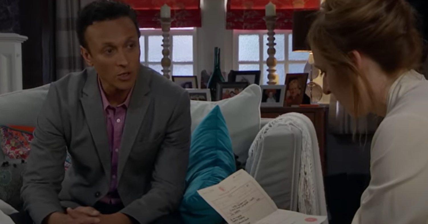 Emmerdale's Jai and Laurel are looking at a piece of paper in shock