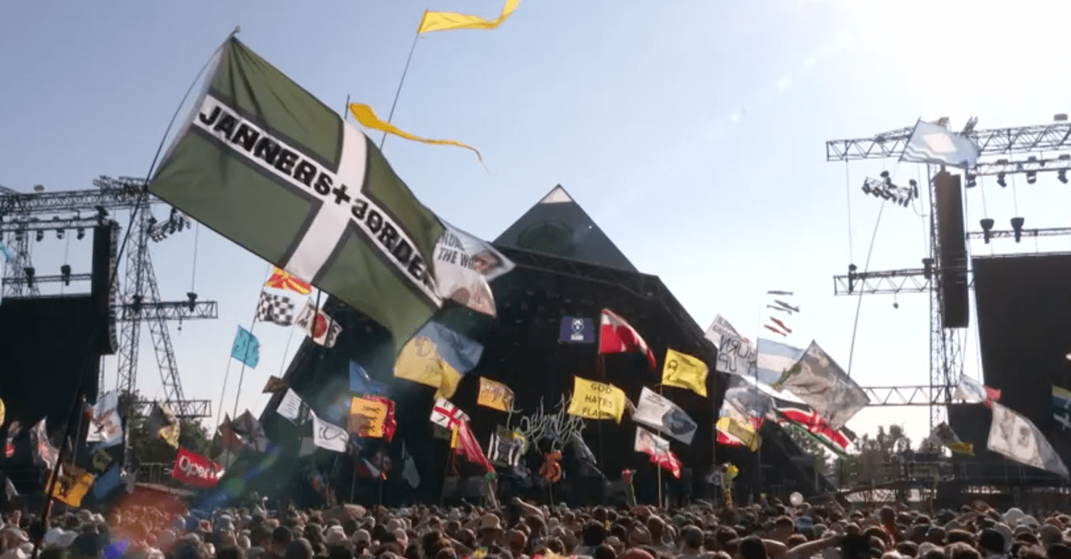 Glastonbury Festival's Pyramid stage with crowd waving flags