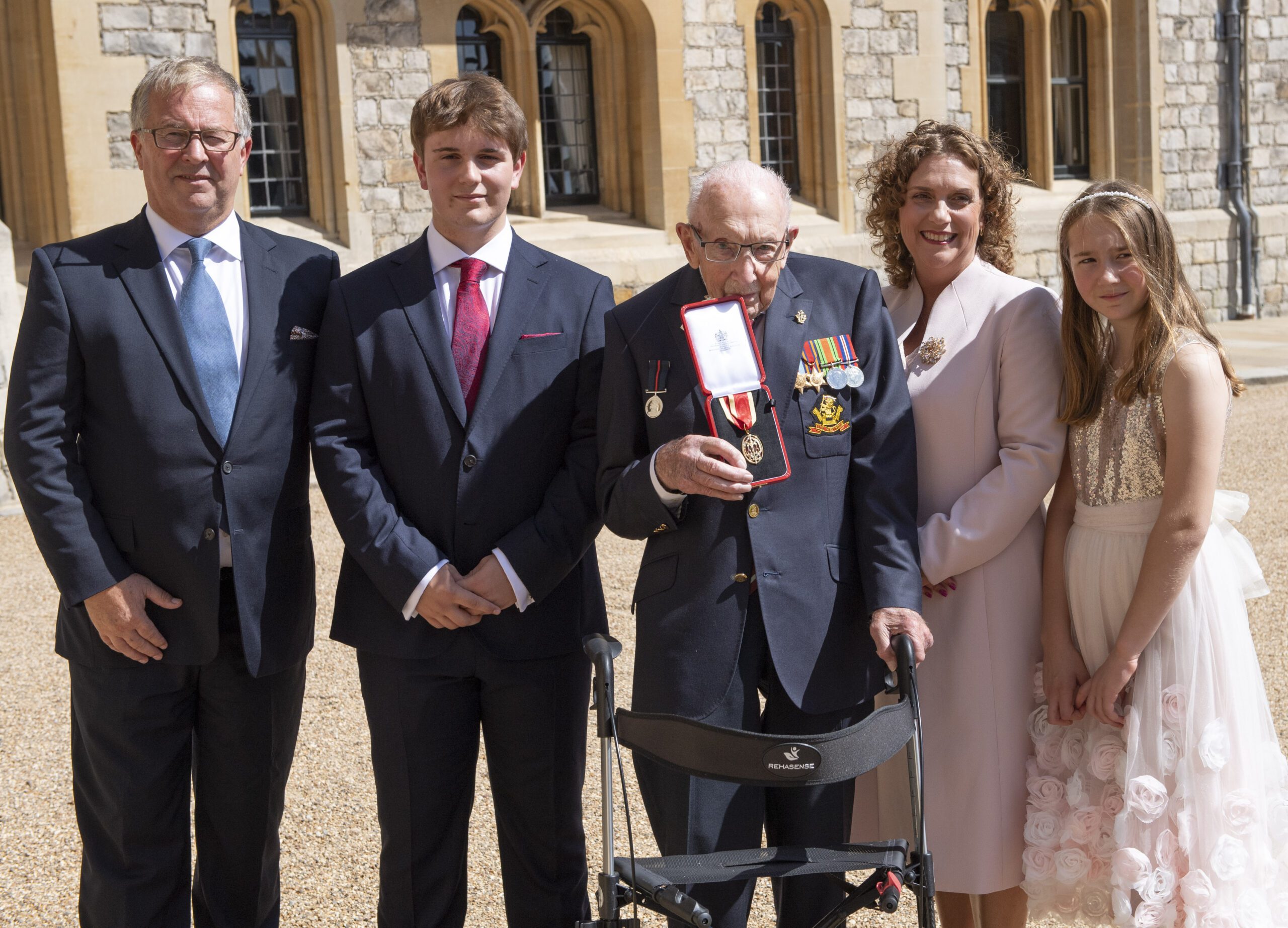 Captain Tom with his family collecting his knighthood at Windsor Castle