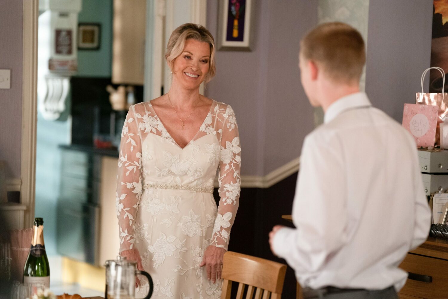 Kathy Beale smiles in her wedding dress