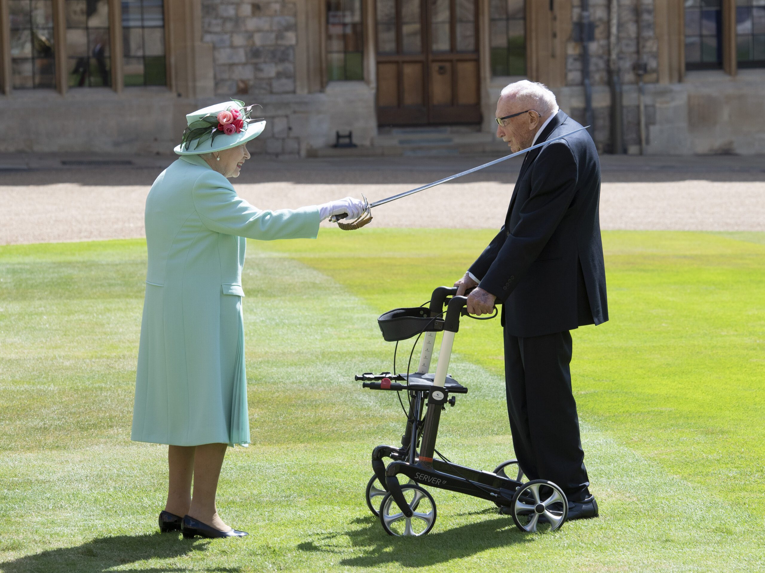 The Queen knighting Captain Tom