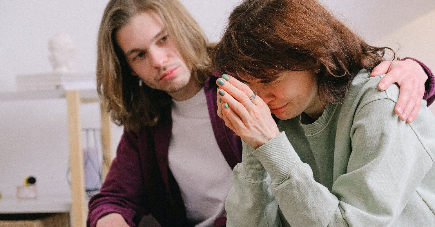 Man comforting woman