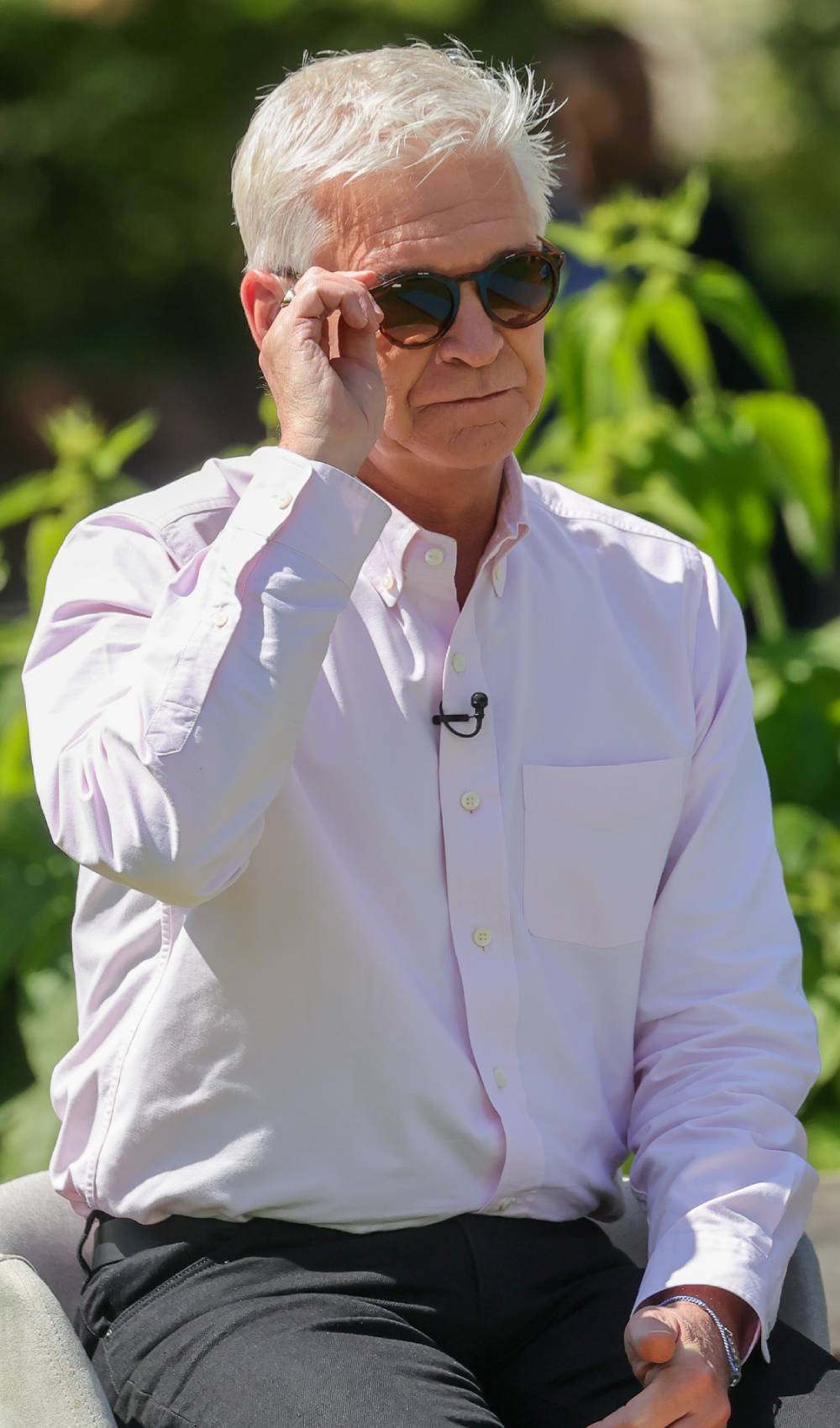 Phillip Schofield adjusts his sunglasses