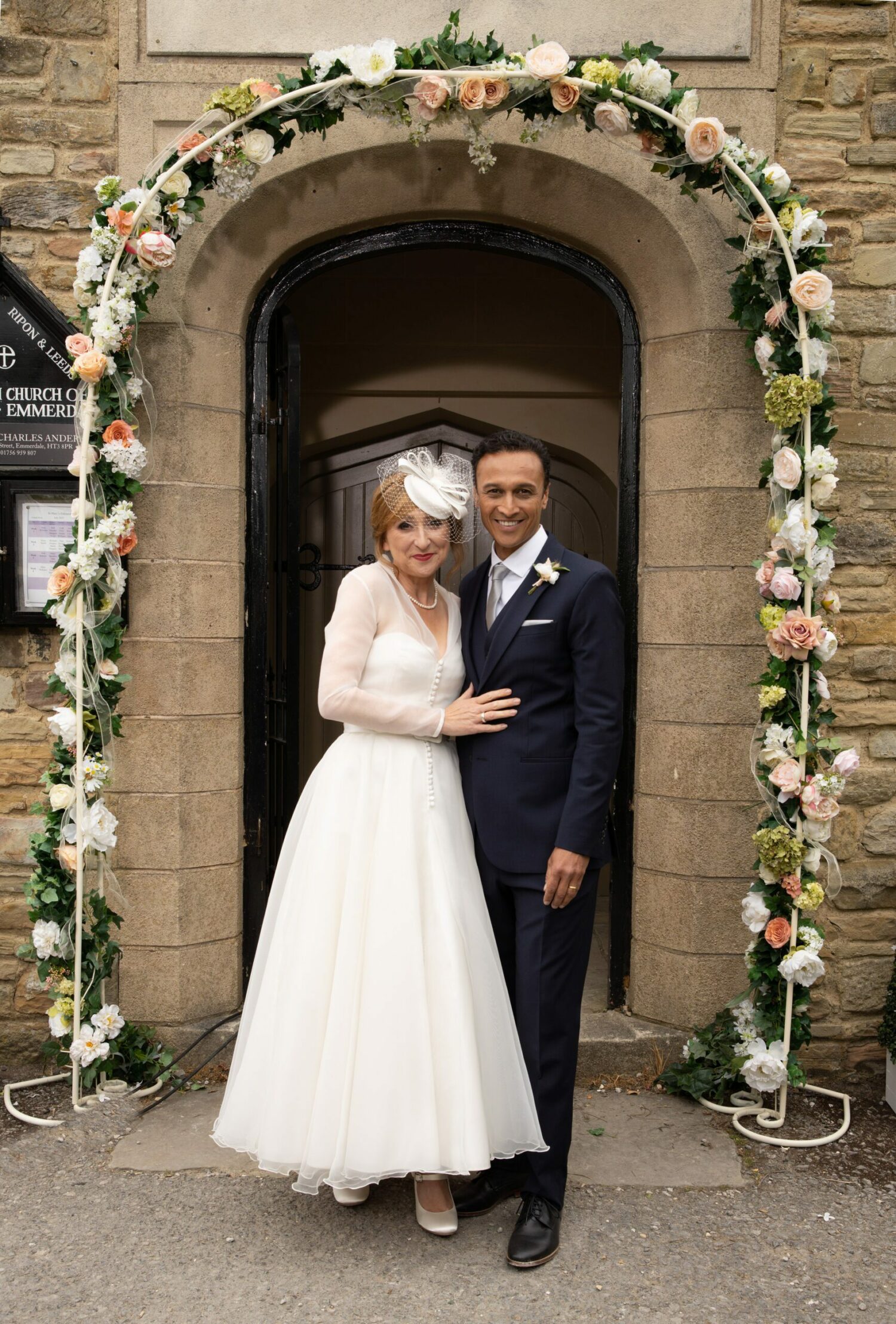 Laurel Thomas and Jai Sharma smile in their wedding outfits
