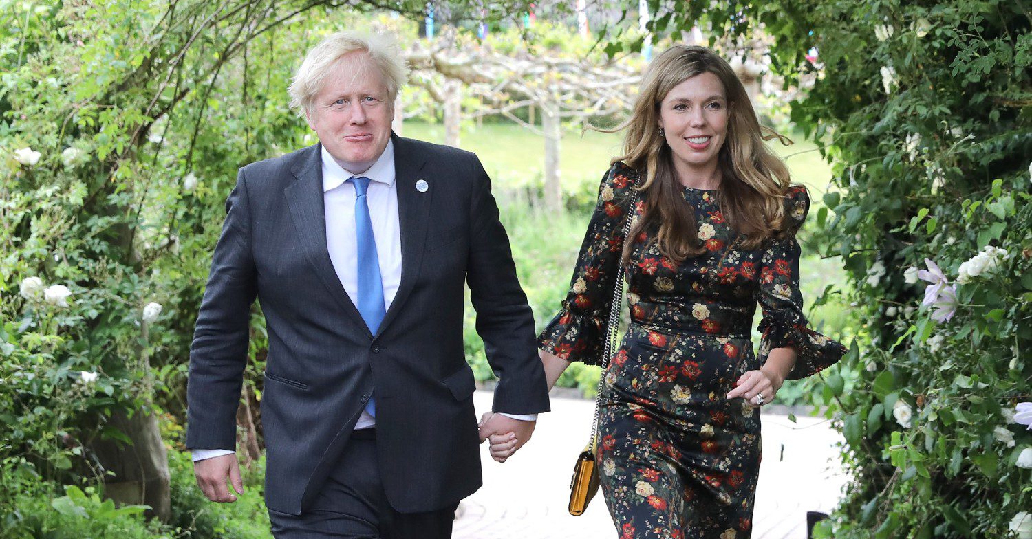 Boris Johnson and wife Carrie holding hands and walking