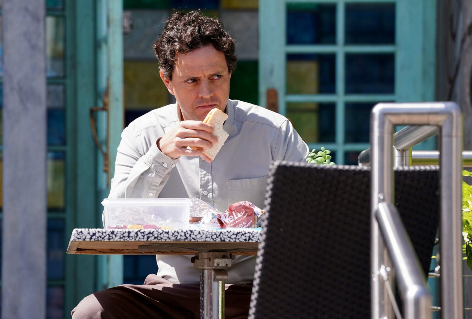Theo looking creepy eating a sandwich on EastEnders