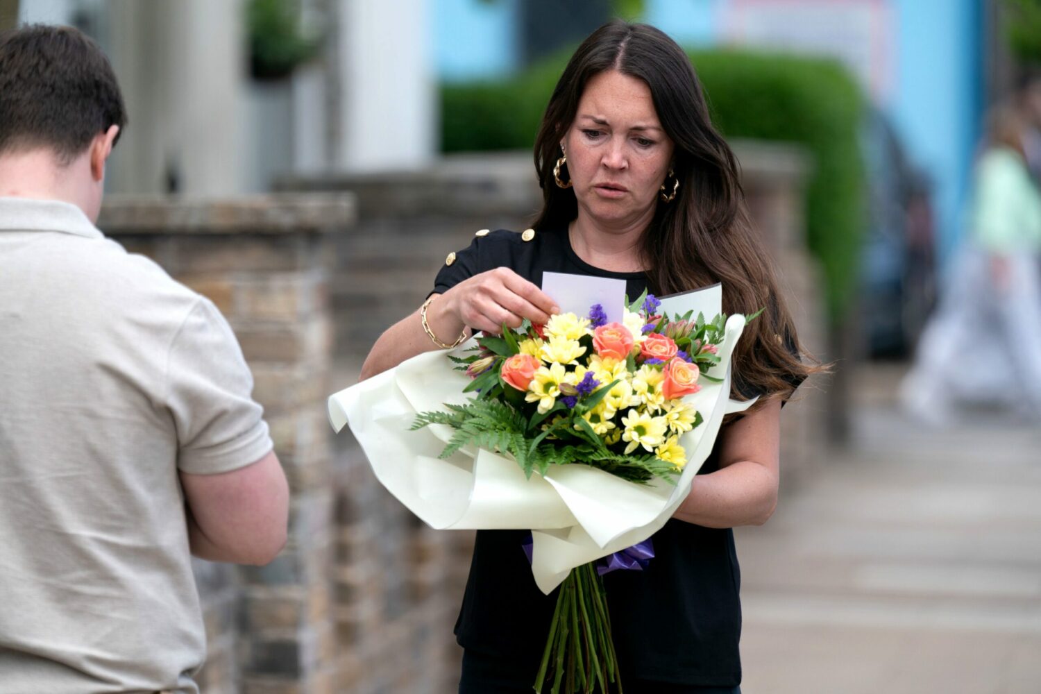 Stacey looking at flowers on EastEnders