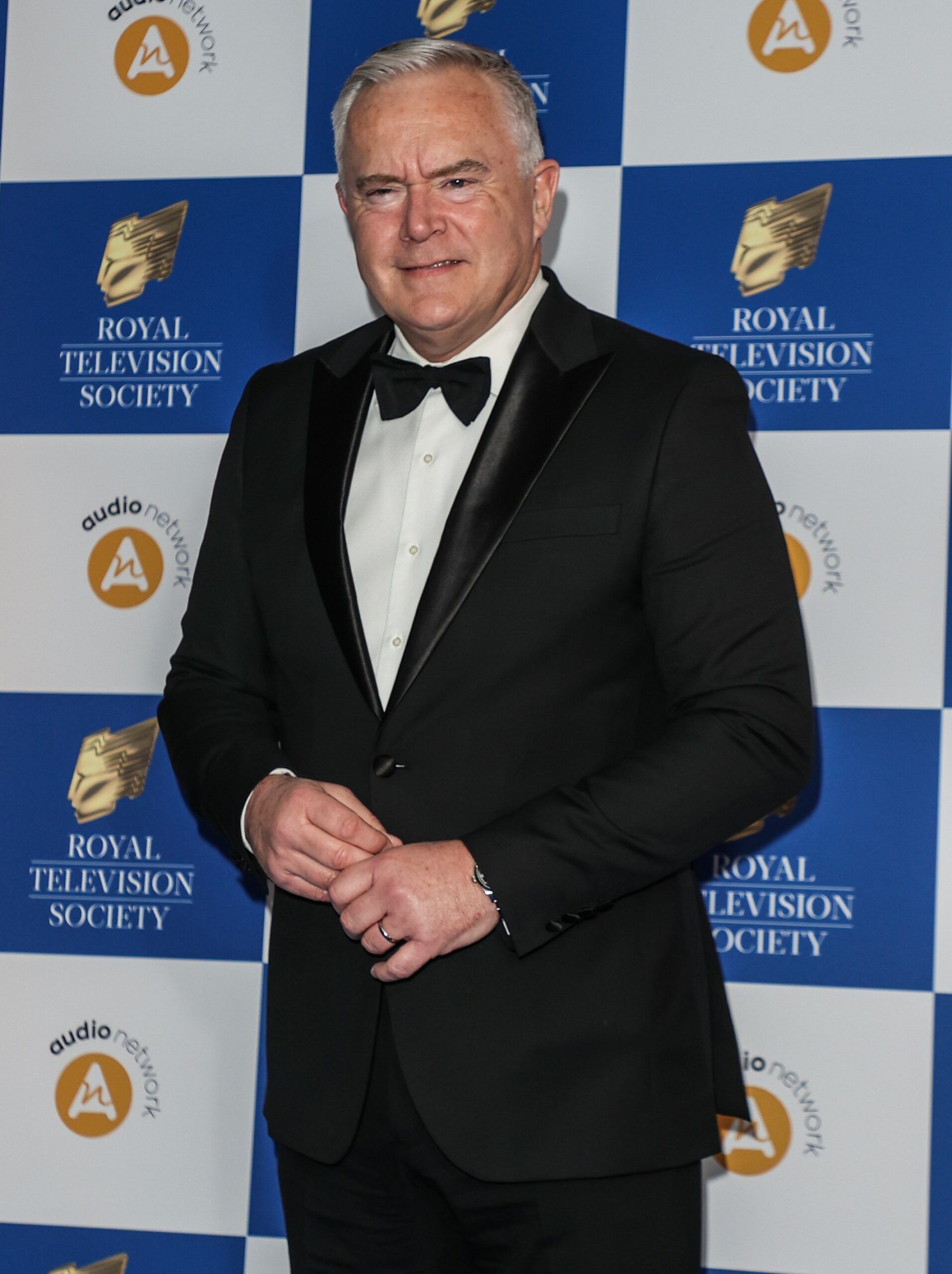 Huw Edwards smiles at event
