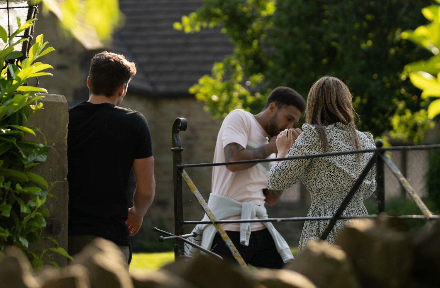 Emmerdale's Billy is holding his face as Gabby tends to him and Nicky stands watching