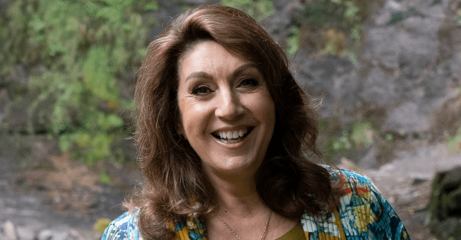 Jane McDonald smiling in the forest