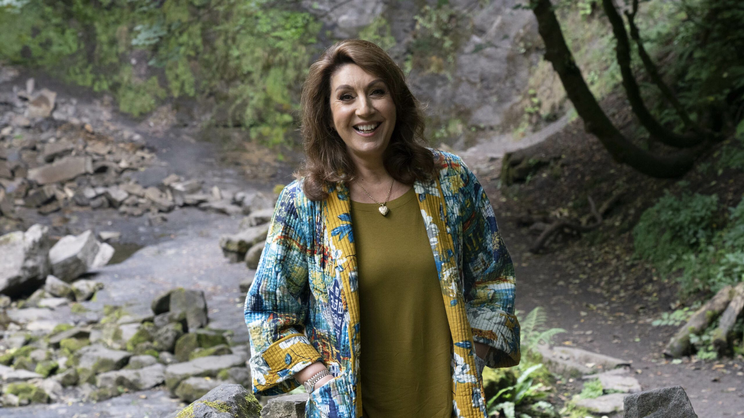 Jane McDonald smiling in the forest