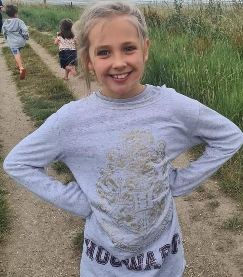 Caitlin Passey smiling in a field