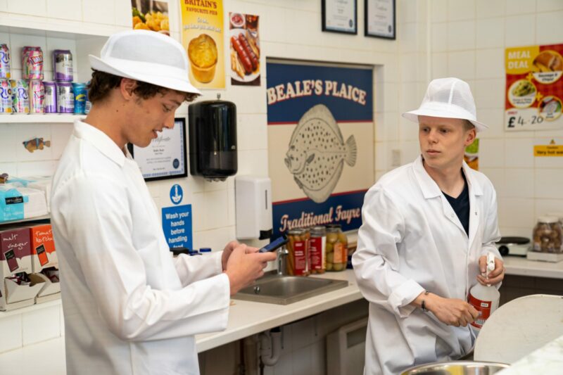Freddie and Bobby at work in the chippy on EastEnders