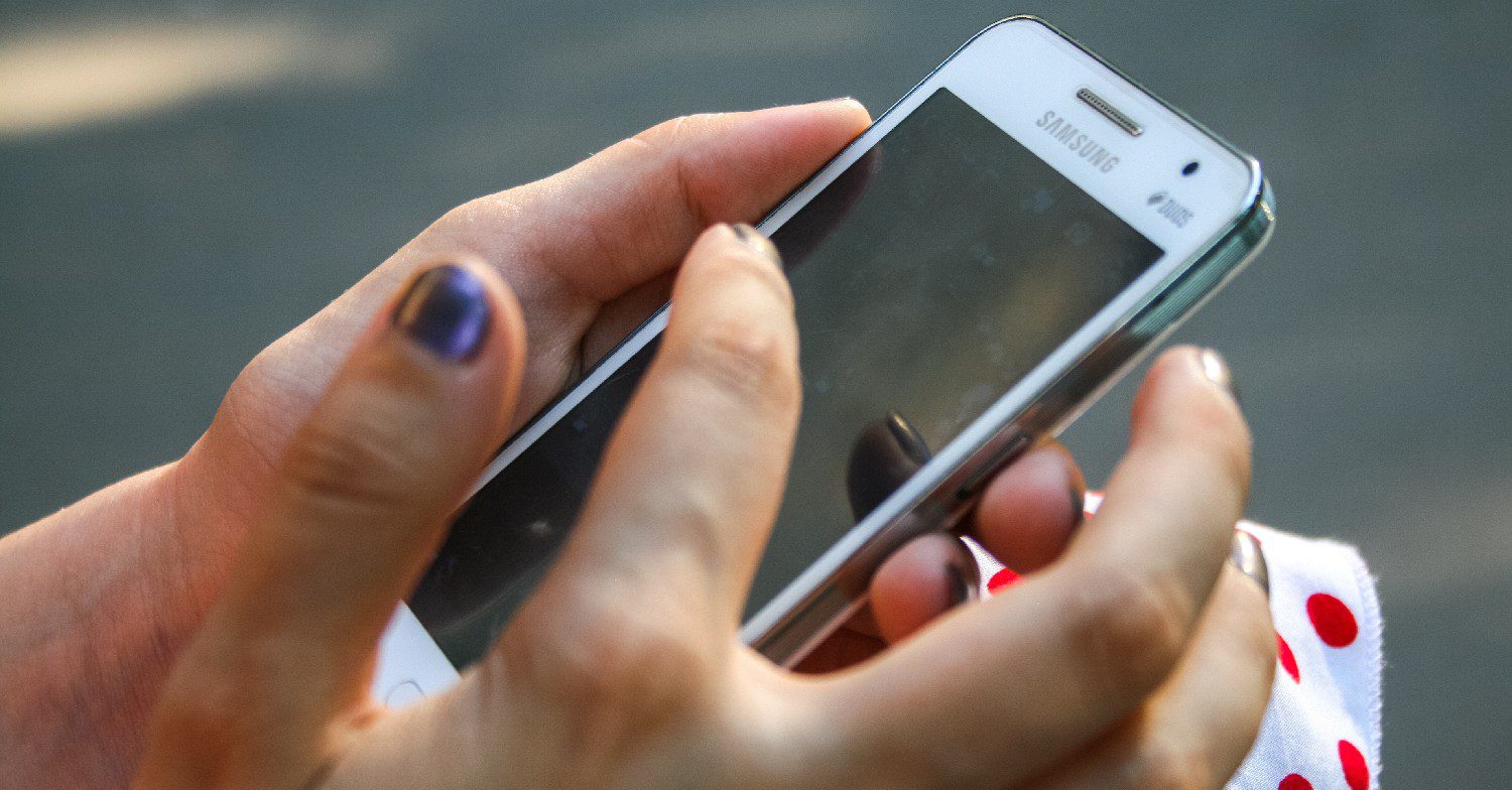 A hand holding a phone