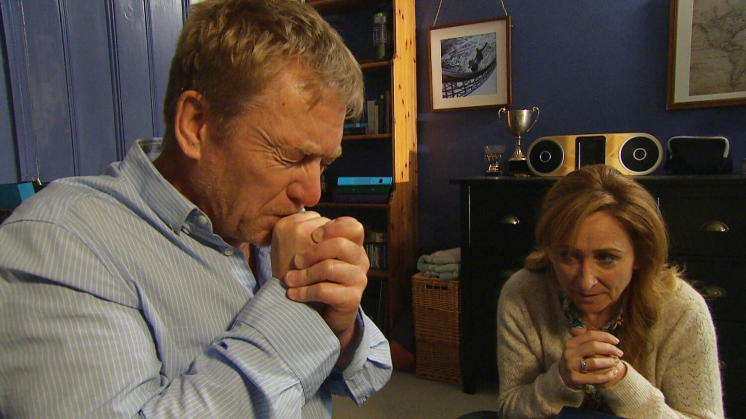 Colin and Laurel pray together as she looks anxious