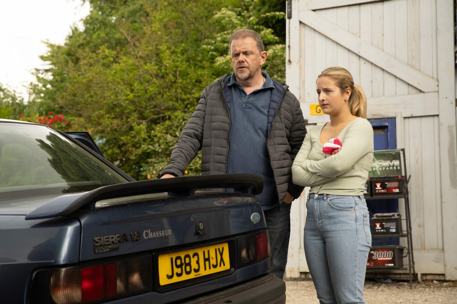 Dan and Amelia by their car on Emmerdale