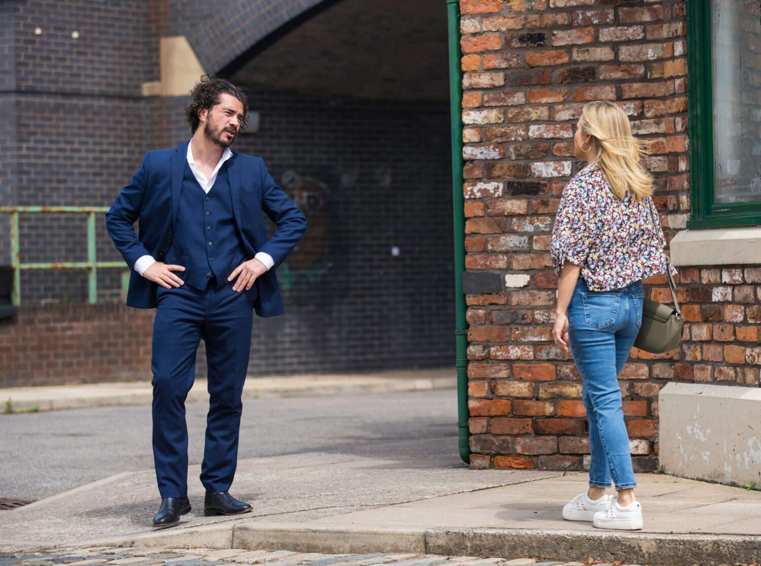 A dishevelled Adam Barlow puts his hands on his hips as he tries to boast to Sarah Barlow on the cobbles