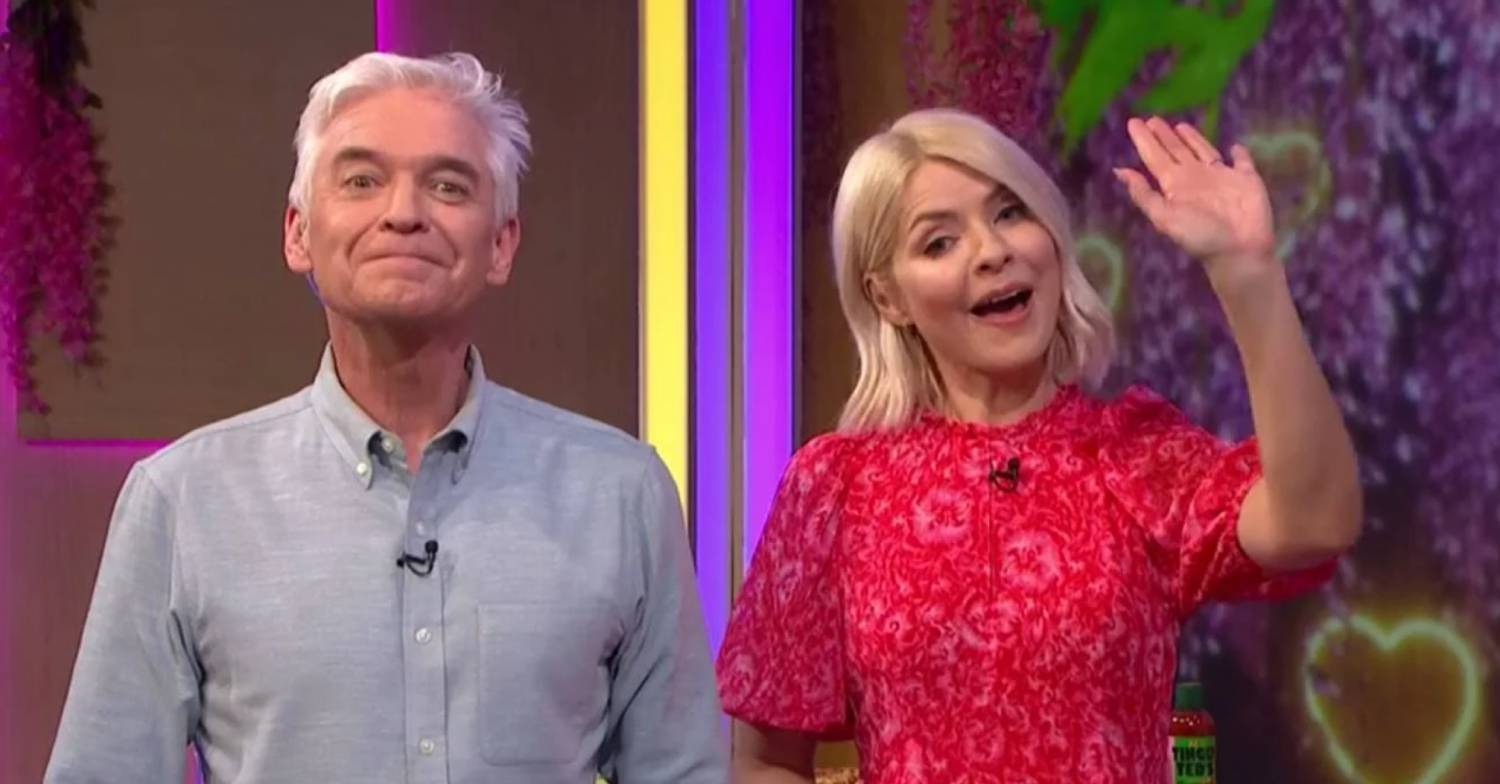 Phillip Schofield lifts his chin, Holly Willoughby waves