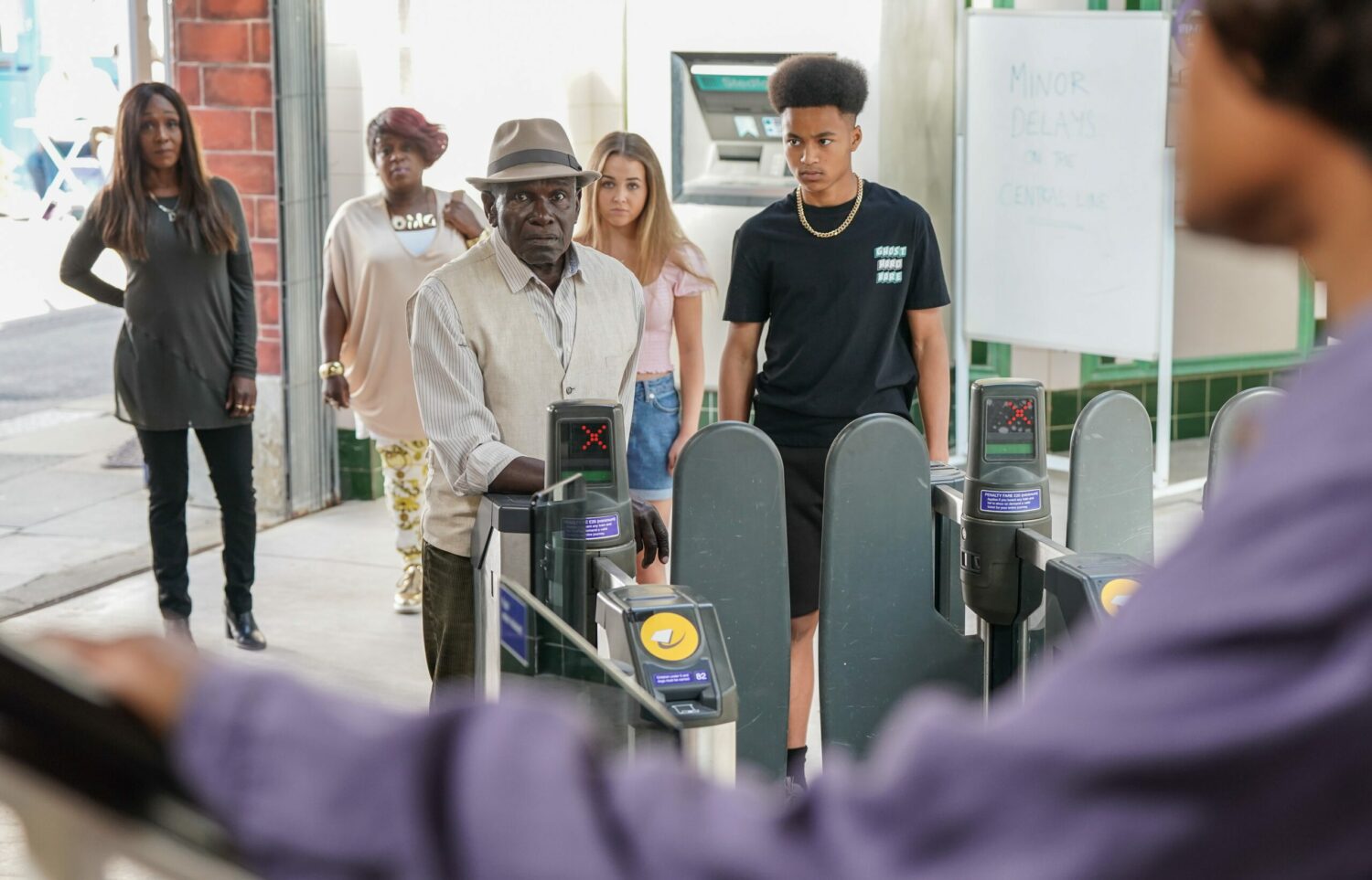 Denise, Kim, Amy, Denzel and Patrick at the tube station watching Yolande prepare to leave 