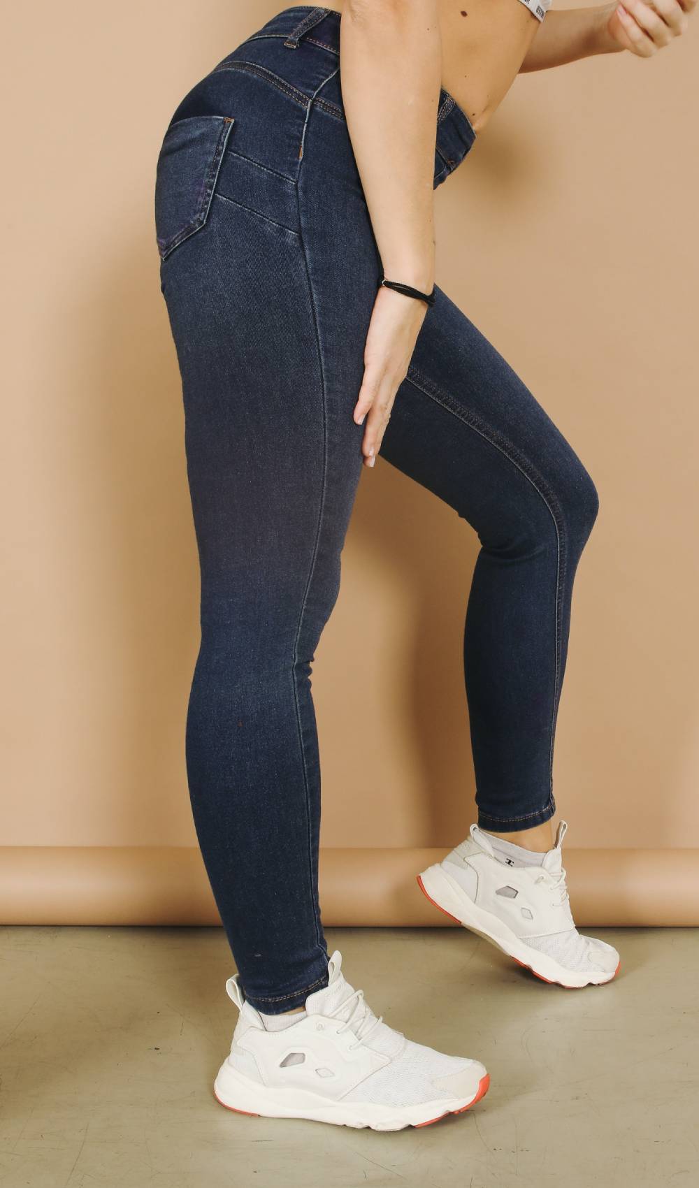 A woman wears tight jeans