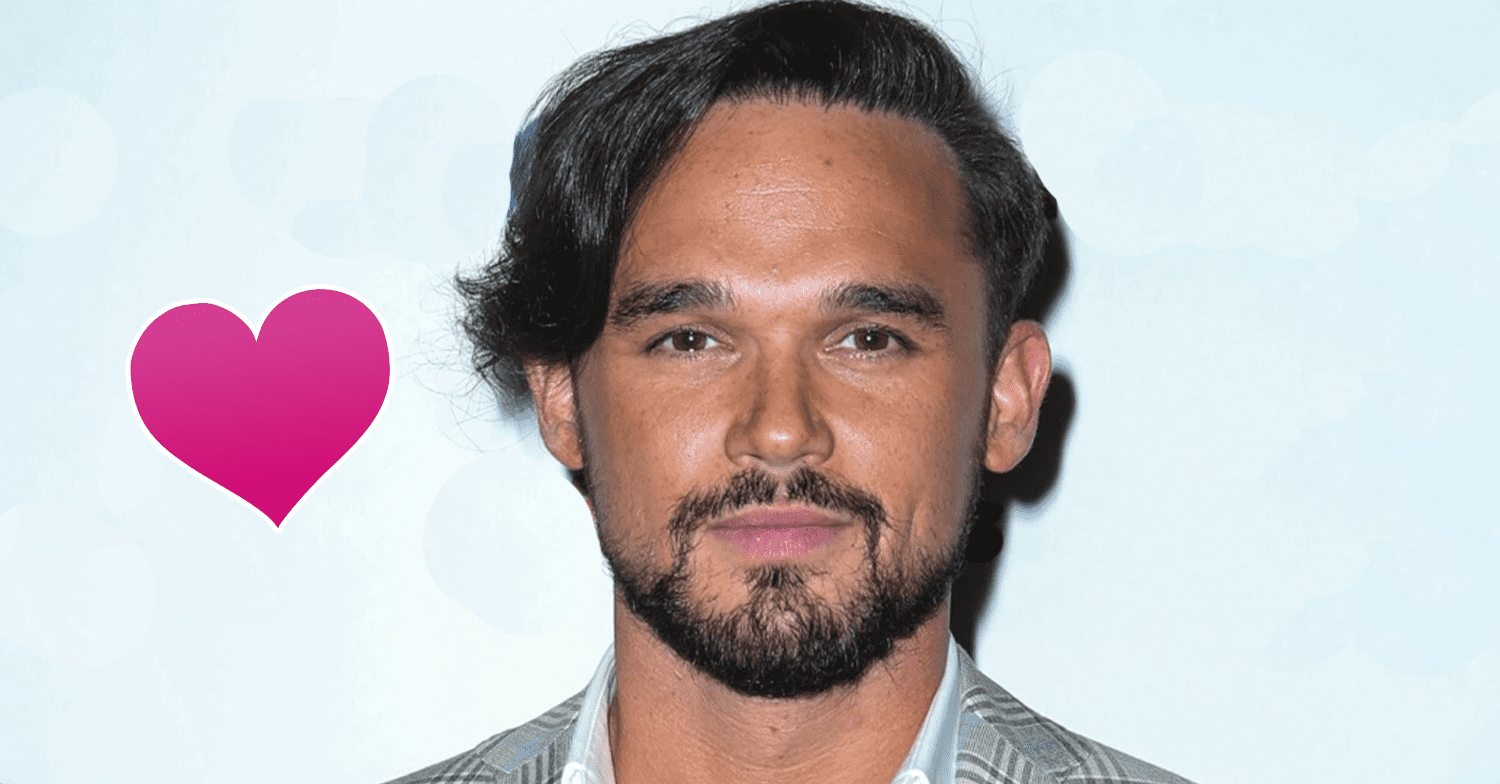 Gareth Gates standing against a white background with a pink heart next to his head