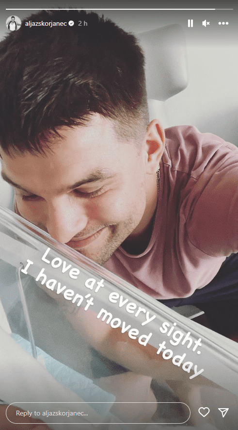 Aljaz Skorenjac gazes into crib of his newborn daughter