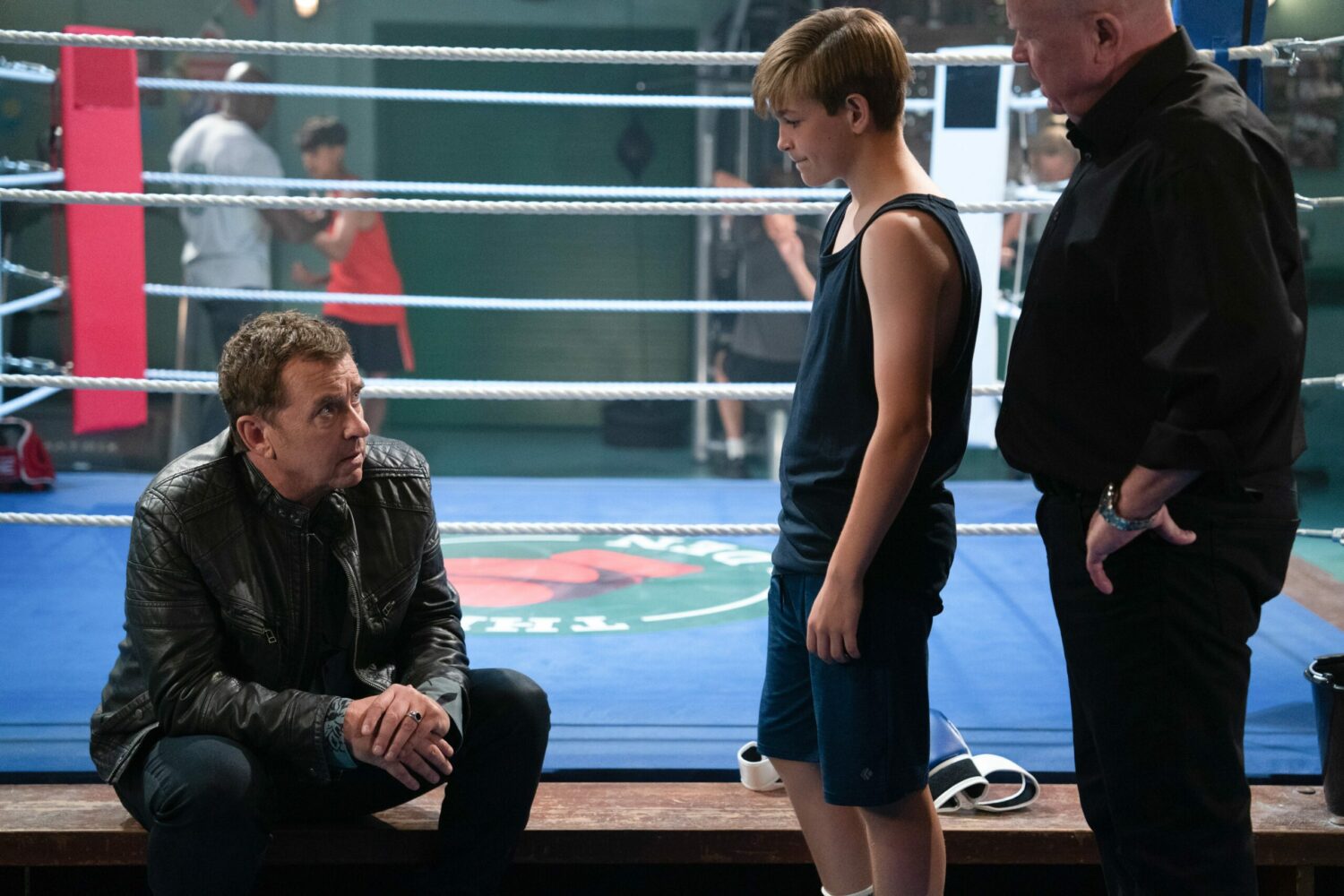 Alfie looks downbeat as he talks to Tommy and Phil in Boxing Den in EastEnders