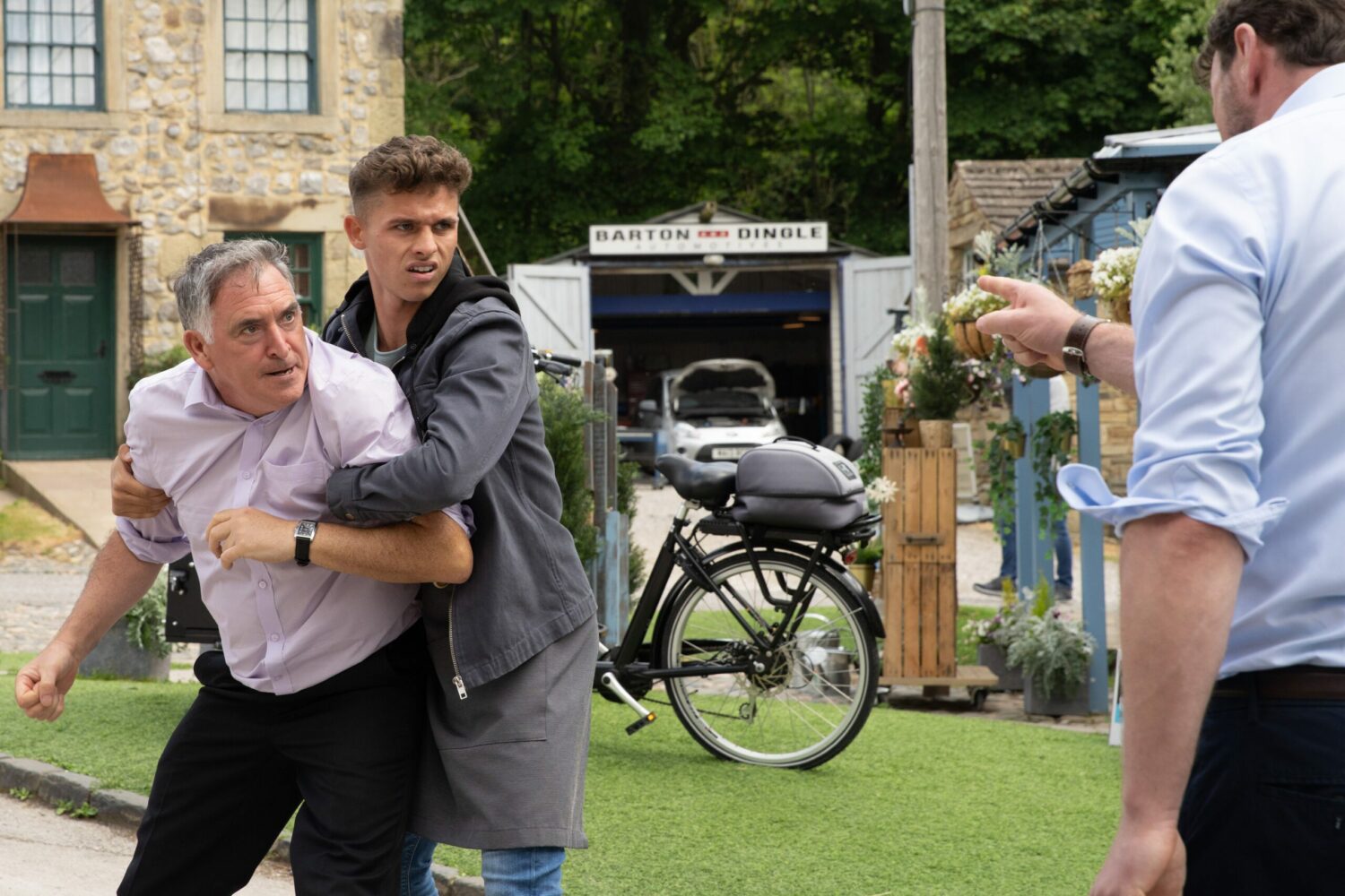 The villagers try to pull Bob away from Liam on Emmerdale