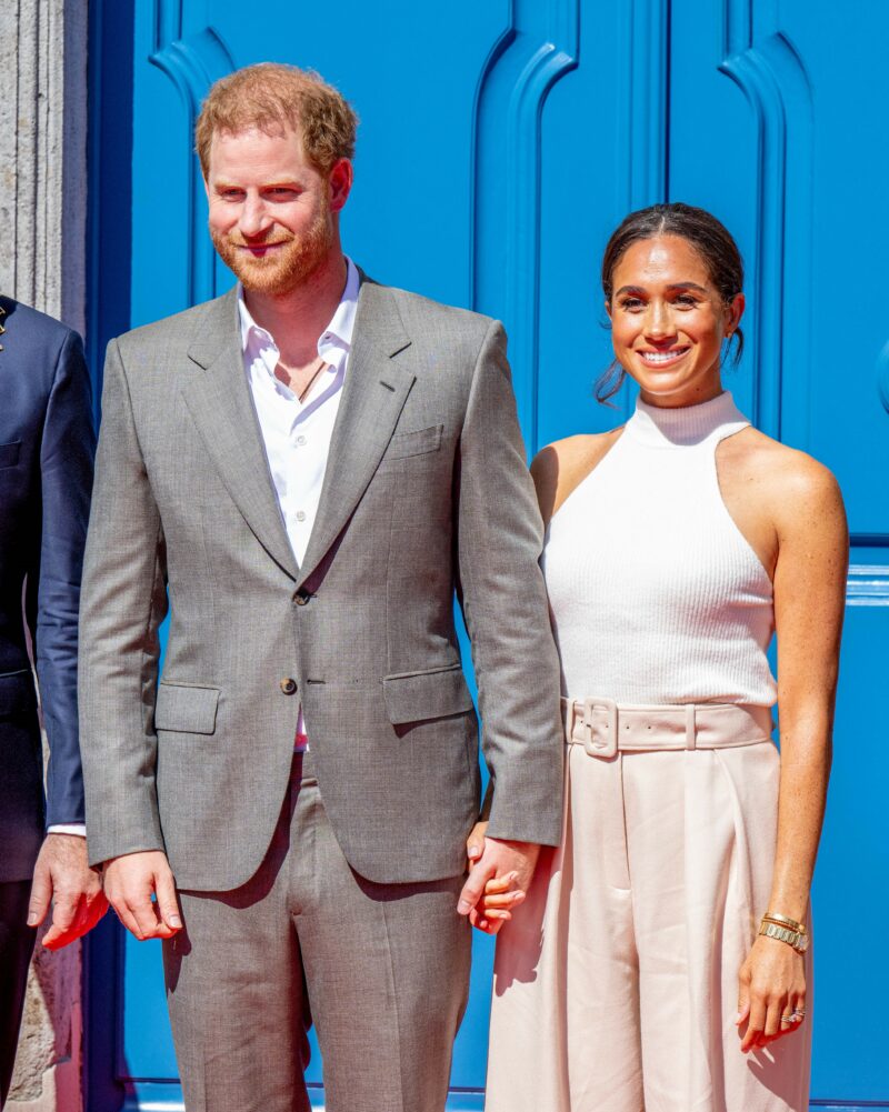 Prince Harry and Meghan Markle smiling at event