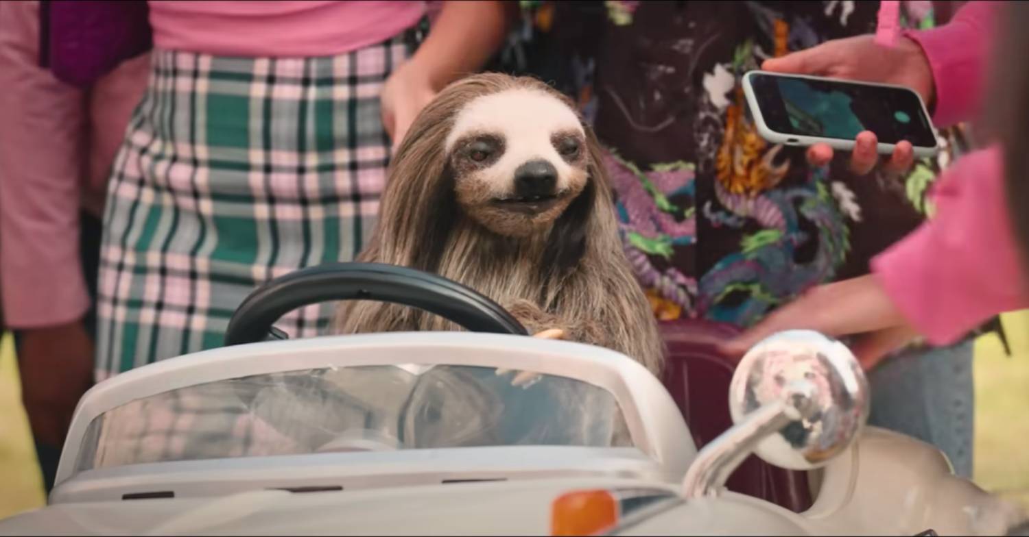 Sloth drives a car in the Slotherhouse trailer