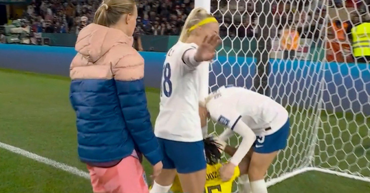 Chloe Kelly, Alex Greenwood and Hannah Hampton console the player and guard her from cameras
