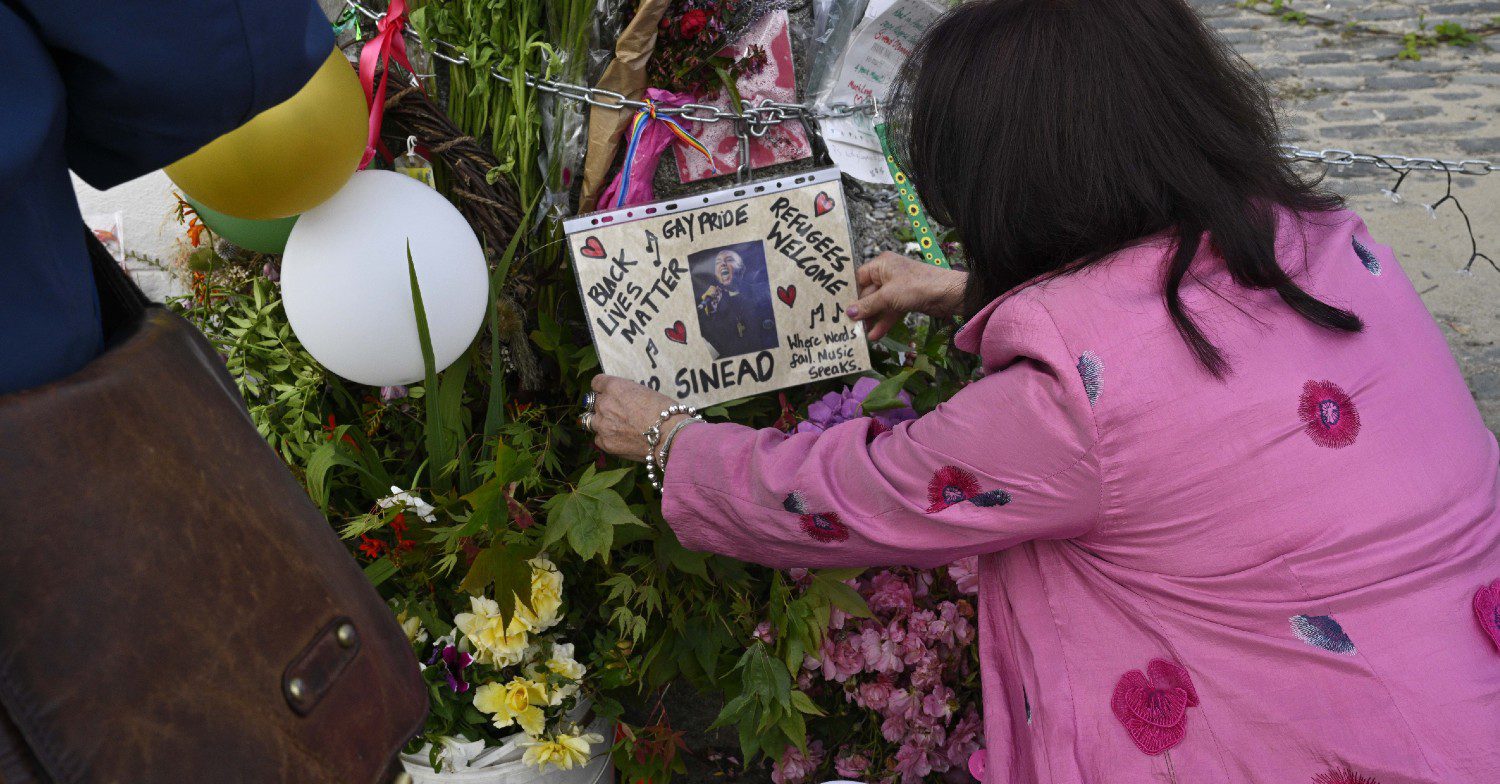 Woman looks at tributes left to Sinead O'Connor