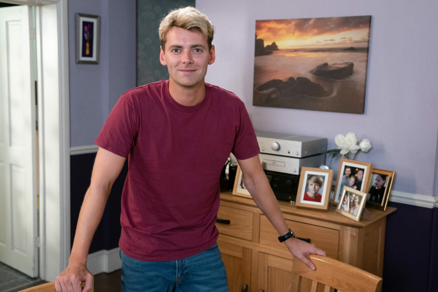 Peter Beale in EastEnders smiles in the Beales' living room