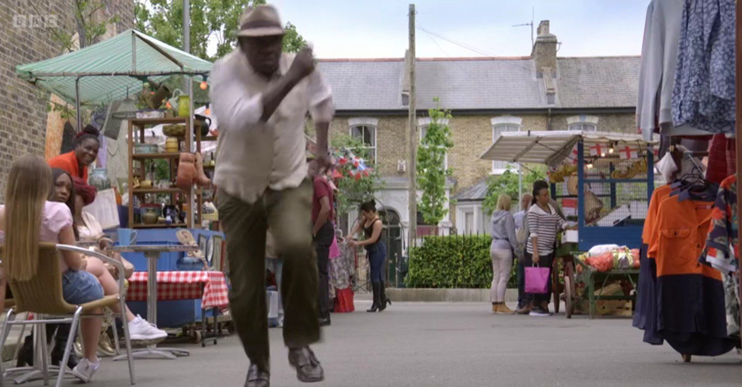 Patrick running through Albert Square on EastEnders