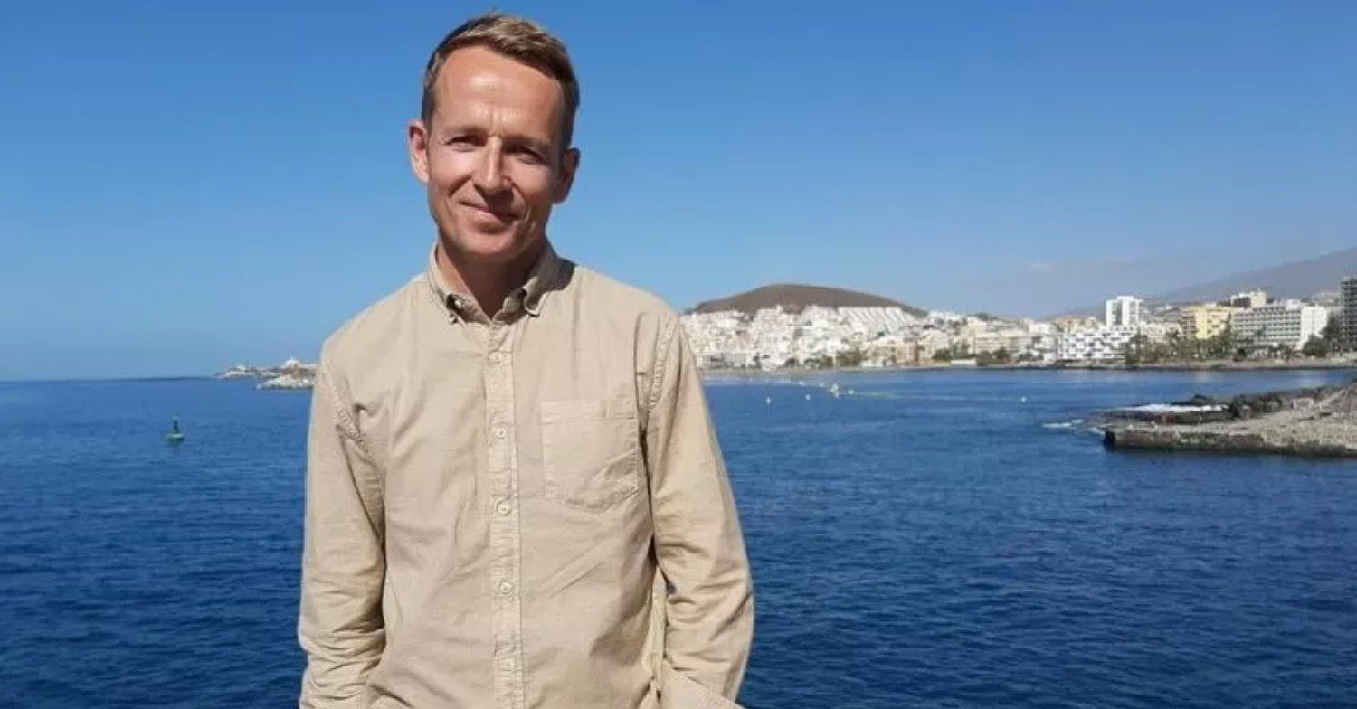 Jonnie irwin in front of a beach