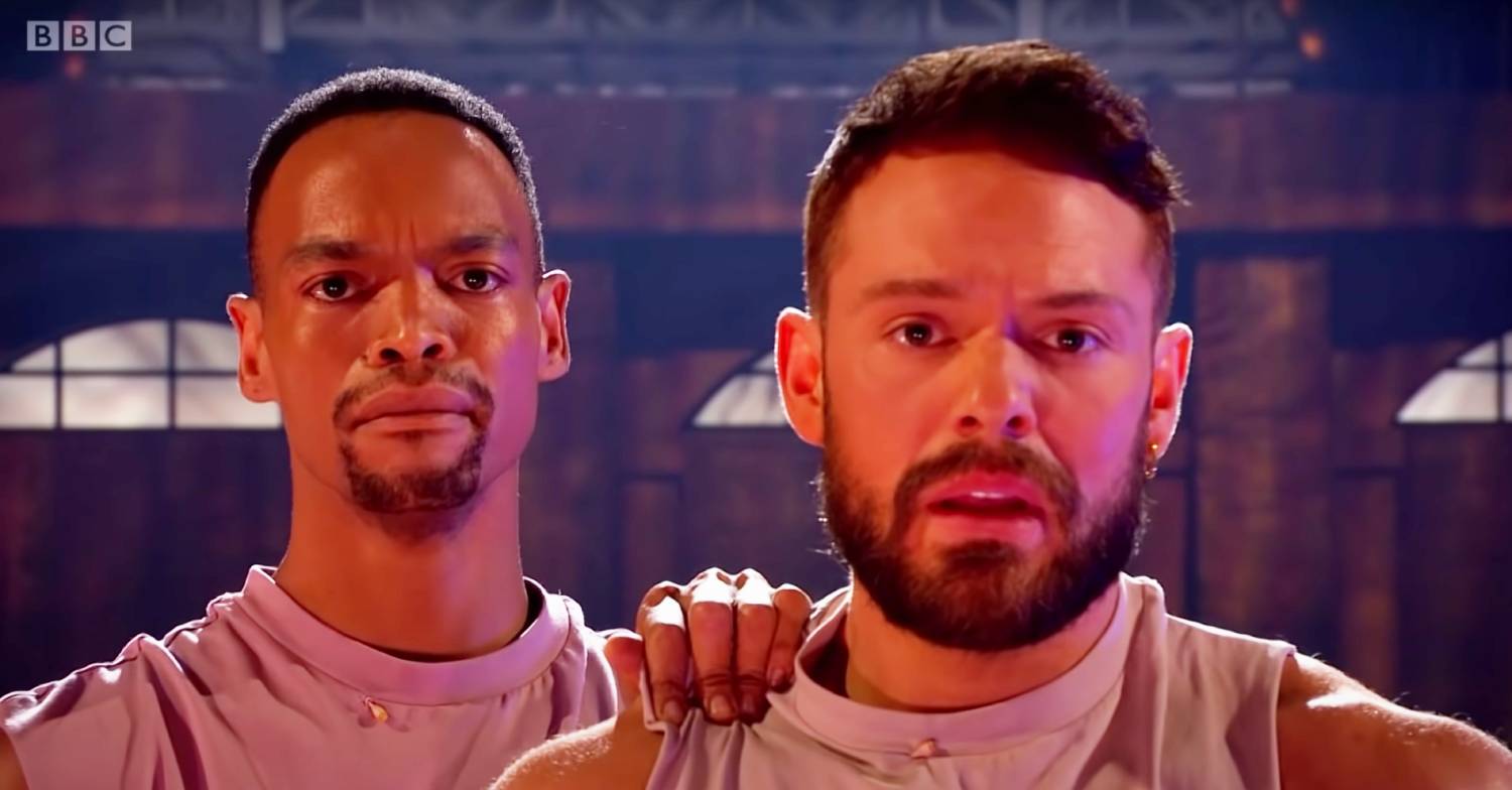 Strictly pro Johannes Radebe places a hand on the shoulder of John Whaite