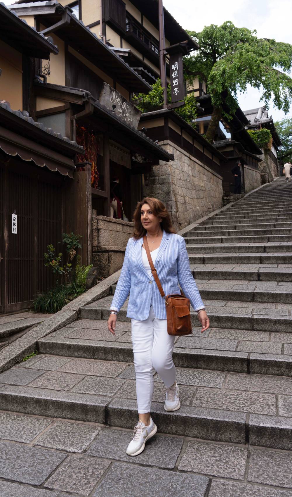 Jane McDonald walks down steps in Kyoto, Japan
