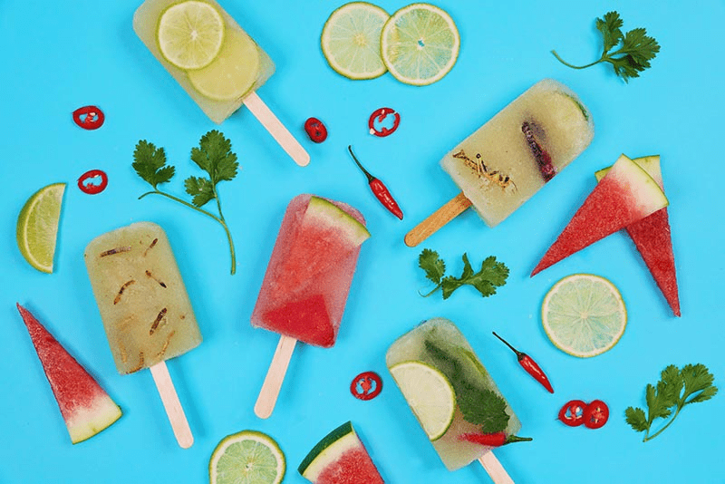 Selection of ice lollies on a turquoise background