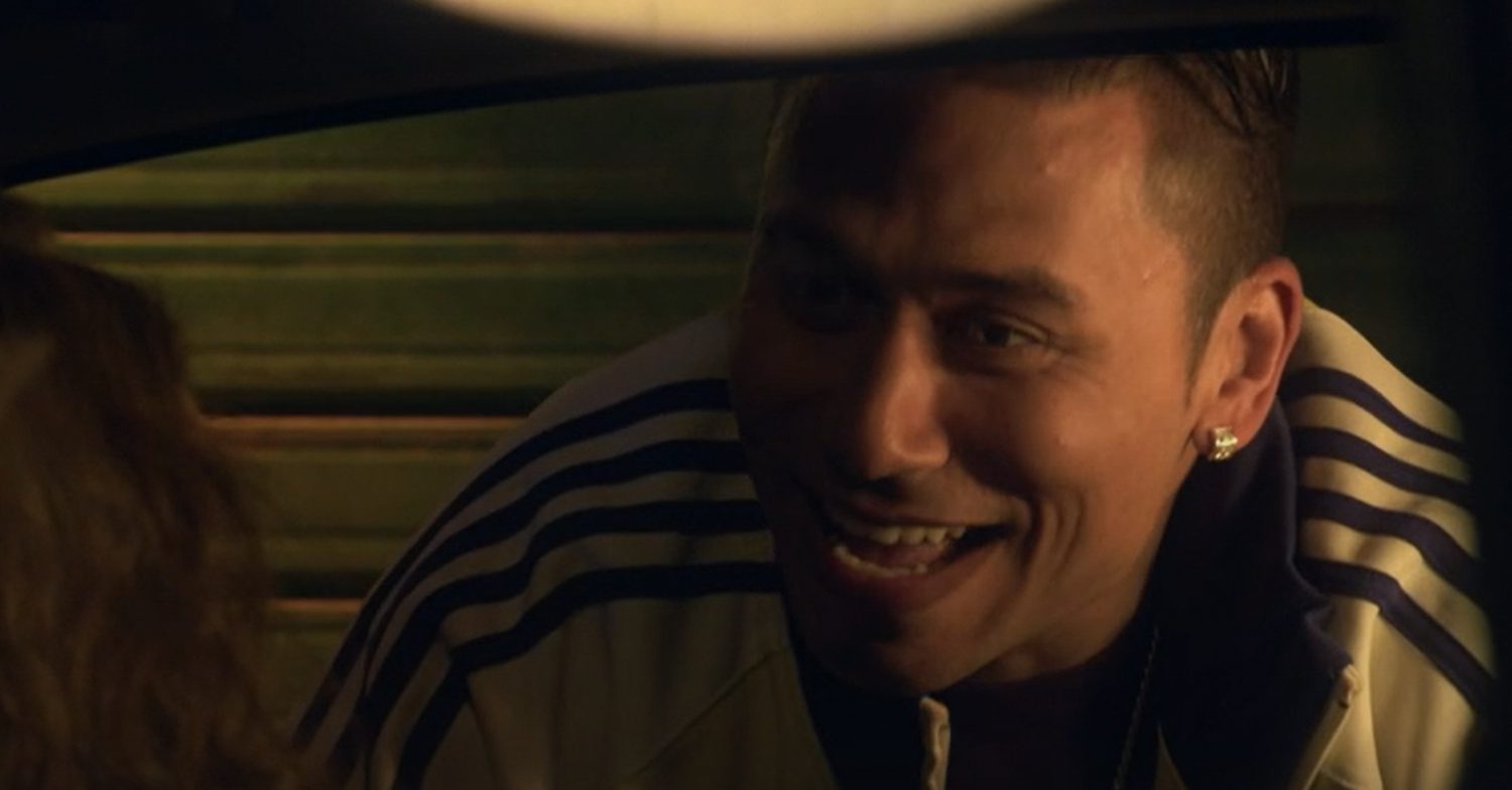 EastEnders' Fatboy is smiling whilst peering into a car window